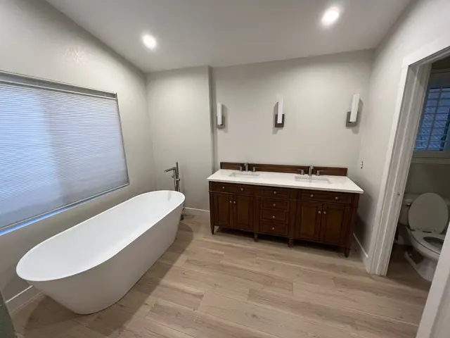 Remodeled bathroom with a freestanding tub and double vanity