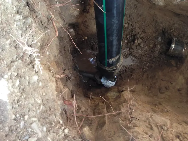 New pipe going into the ground during a trenchless install